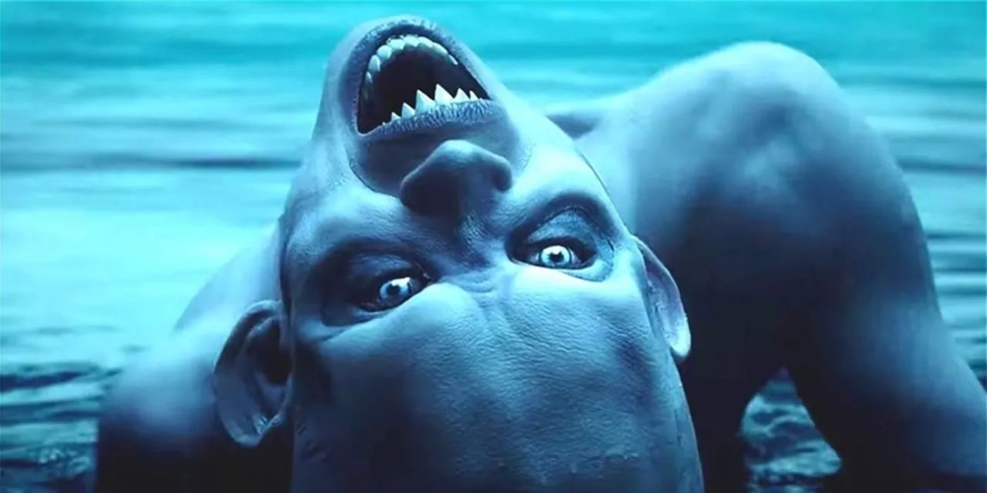 A Flesh Phantom comes out of the water upside down with pointy teeth in American Horror Story.