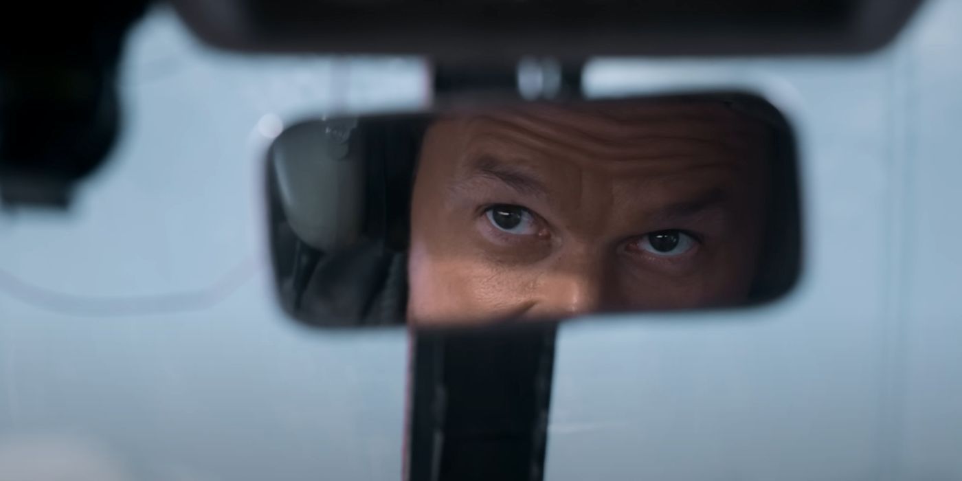Mark Wahlberg as Daryl, looking at the rearview mirror in Flight Risk.