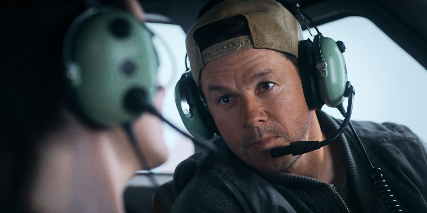 Daryl (Mark Wahlberg) looking at his flight passenger with a headset on in Flight Risk