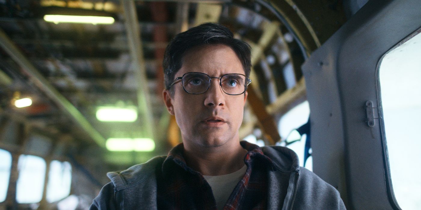 Winston (Topher Grace) in the back of a helicopter looking alarmed in Flight Risk
