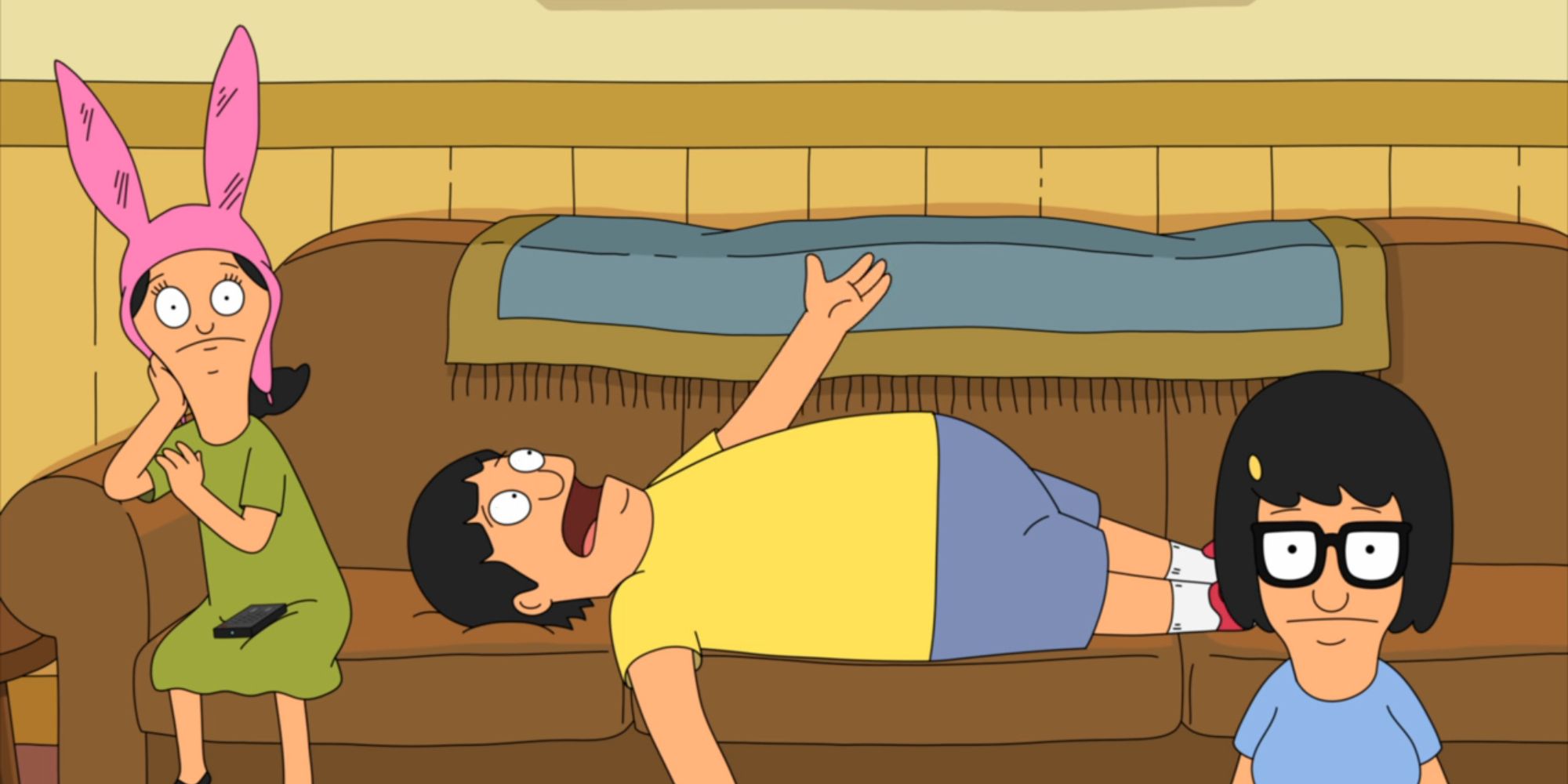 Gene lies on the couch in stress with Tina and Louise sitting beside him in Season 3, Episode 8 of &lsquo;Bob&rsquo;s Burgers.'
