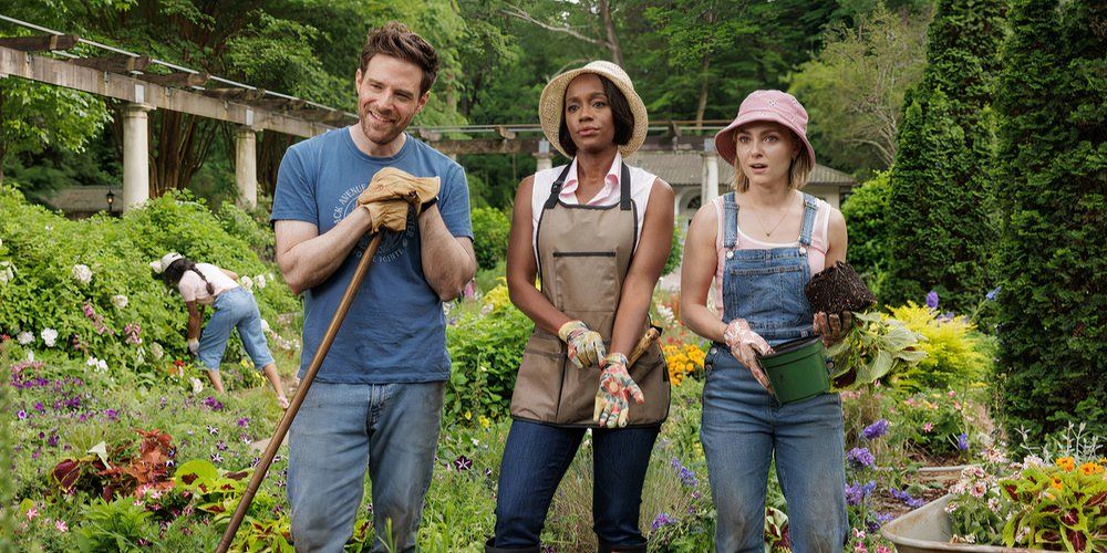 Ben Rappaport as Brett, Aja Naomi King as Catherine, AnnaSophia Robb as Alice in Grosse Pointe Garden Society standing in a garden