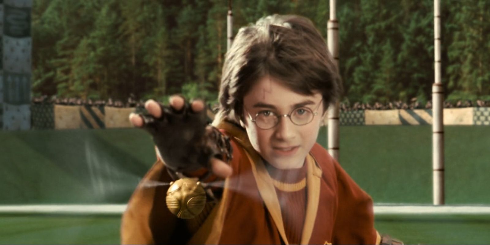 Harry Potter (Daniel Radcliffe) reaches for the Golden Snitch in 'Harry Potter and the Sorcerer's Stone'.