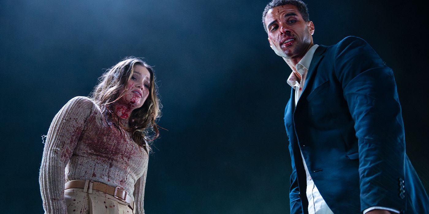 Ally (Olivia Holt) and Jay (Mason Gooding) covered in blood looking down in disgust in Heart Eyes