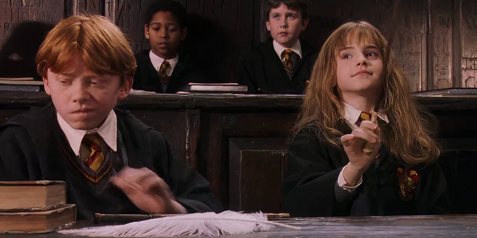 Hermione and Ron sitting side by side in class
