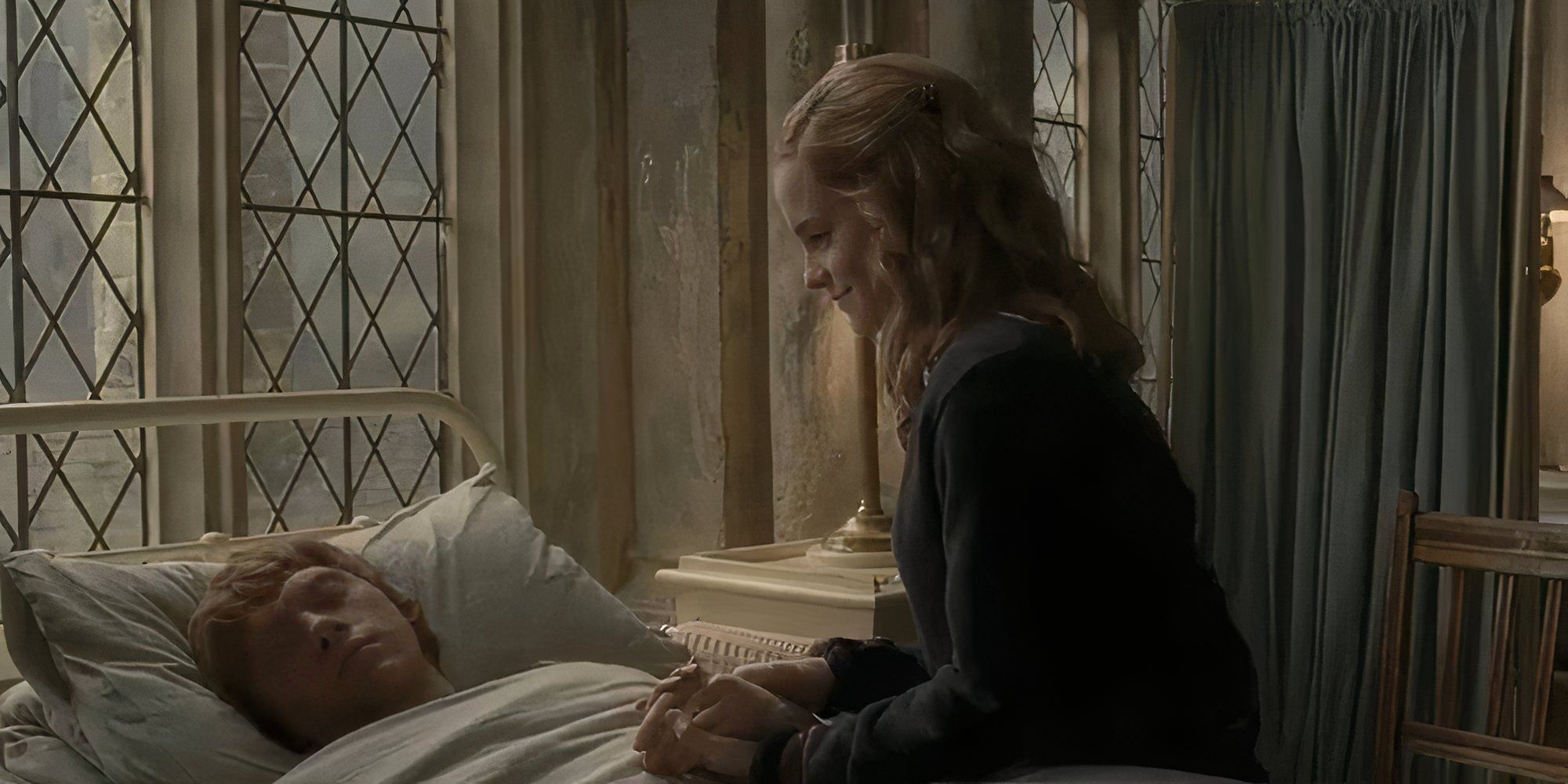 Hermione looks at Ron smiling at his bedside