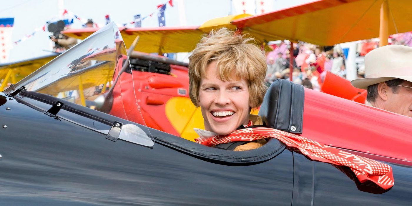 Amelia Earhart in her plane smiling