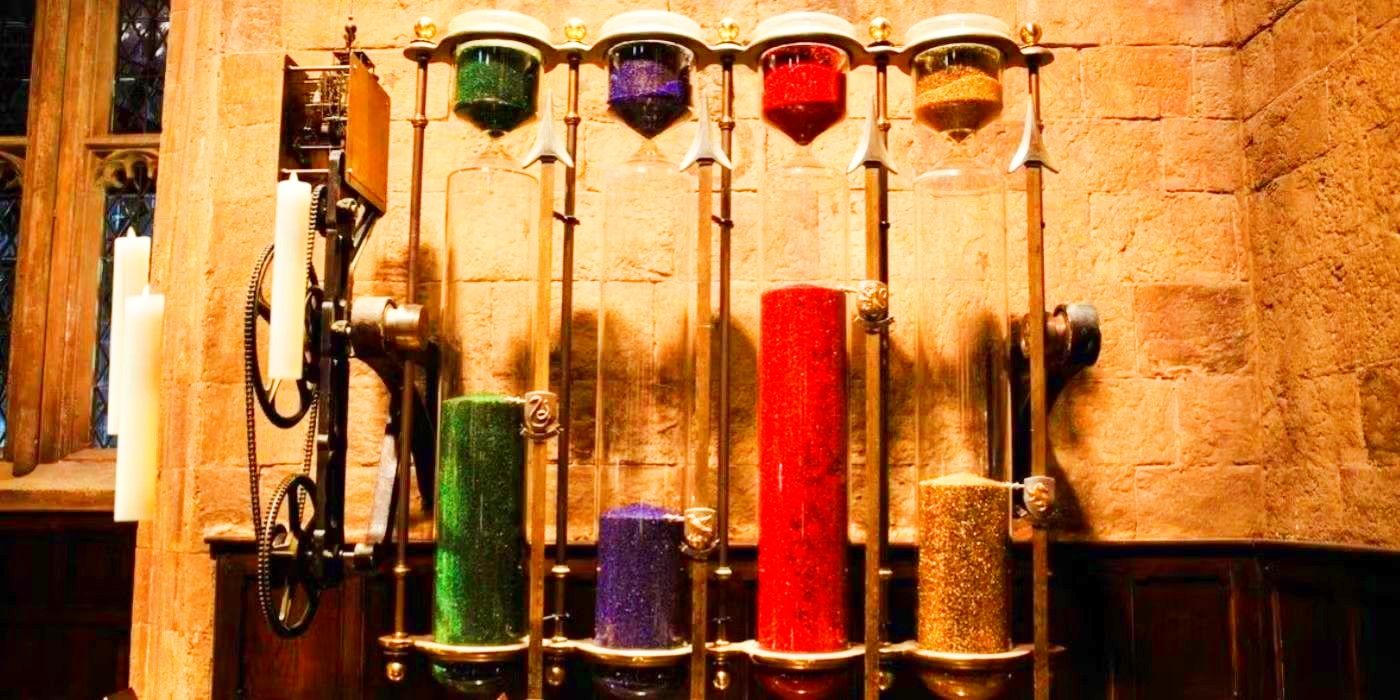 Four hourglasses, each filled with sand of either red, blue, green or yellow, with candles floating next to them.