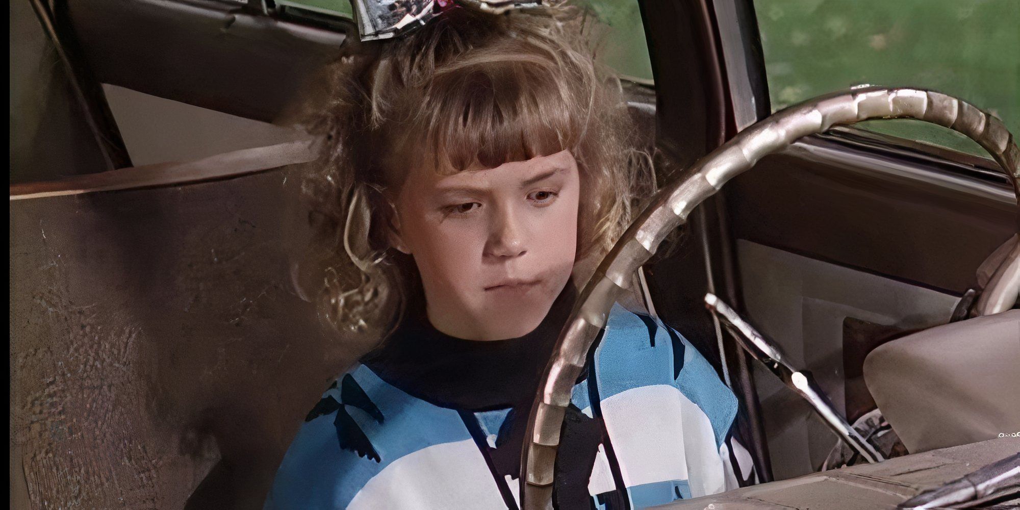 Stephanie Tanner is sitting in the driver&rsquo;s seat of a car.