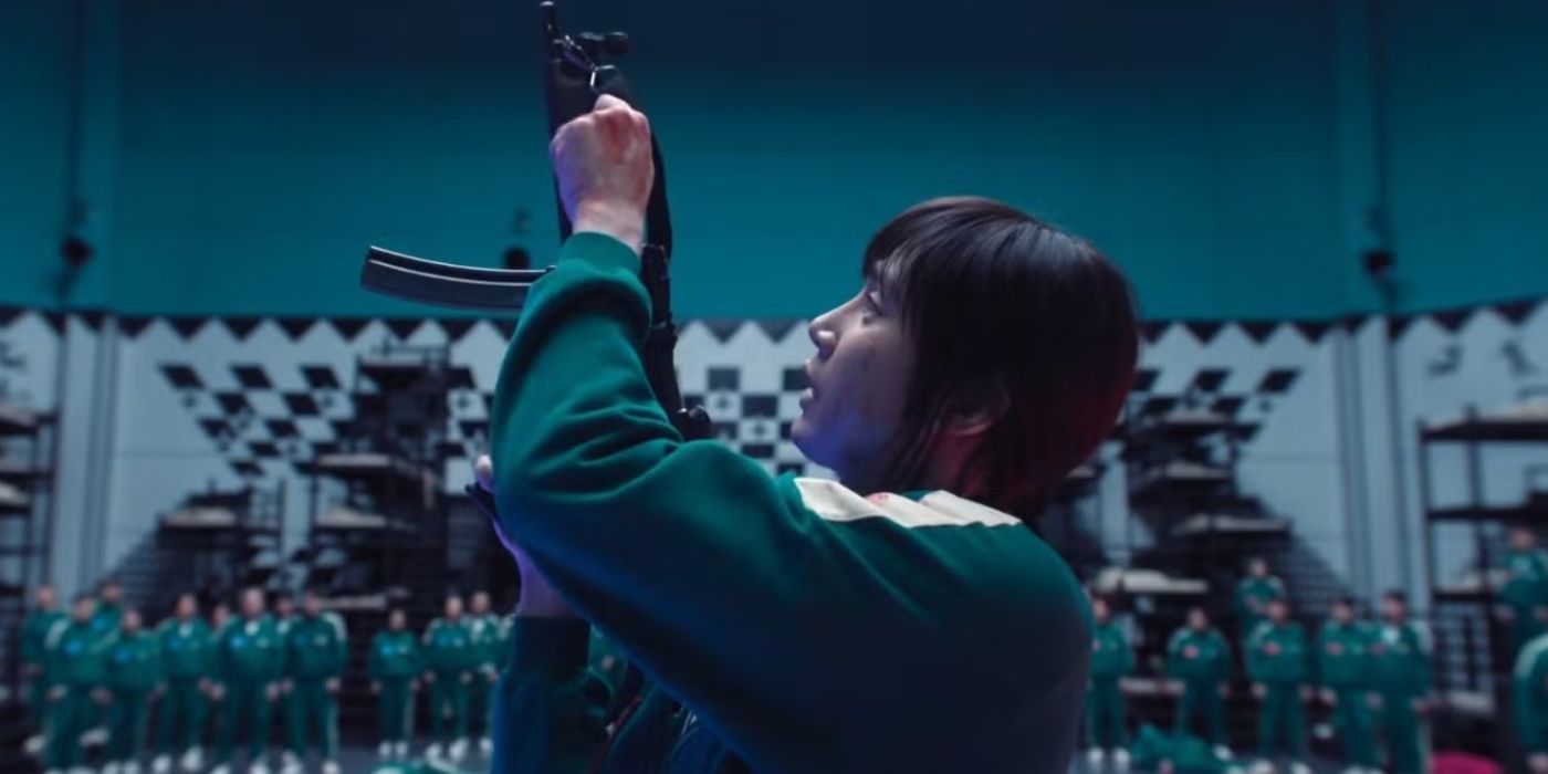 Hyun-ju shows other contestants how to reload a gun in Squid Game.