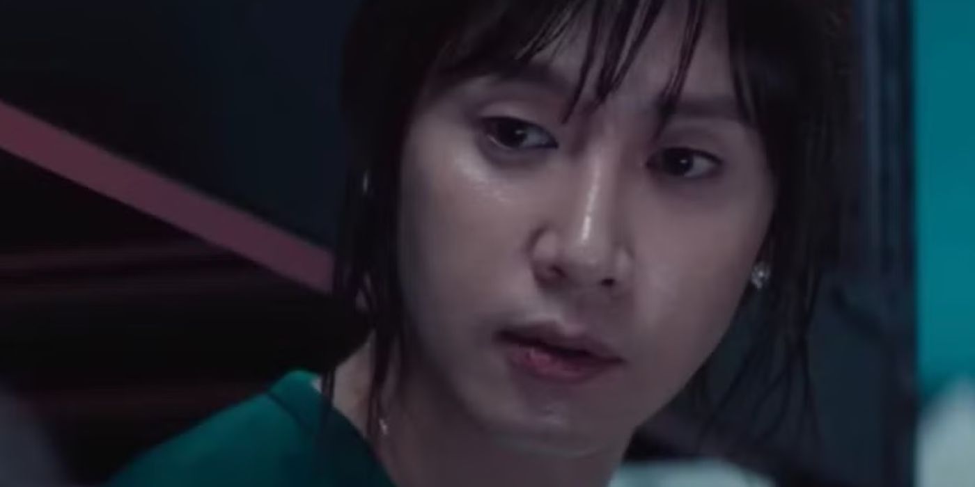 Hyun-ju looks over at Young-mi mid-conversation in Squid Game.