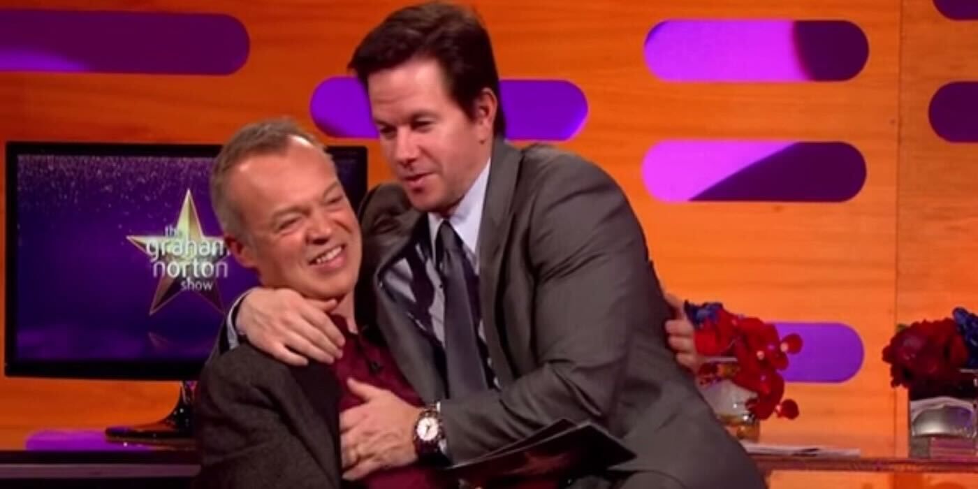 Mark Wahlberg sitting on Graham Norton's lap on The Graham Norton Show 