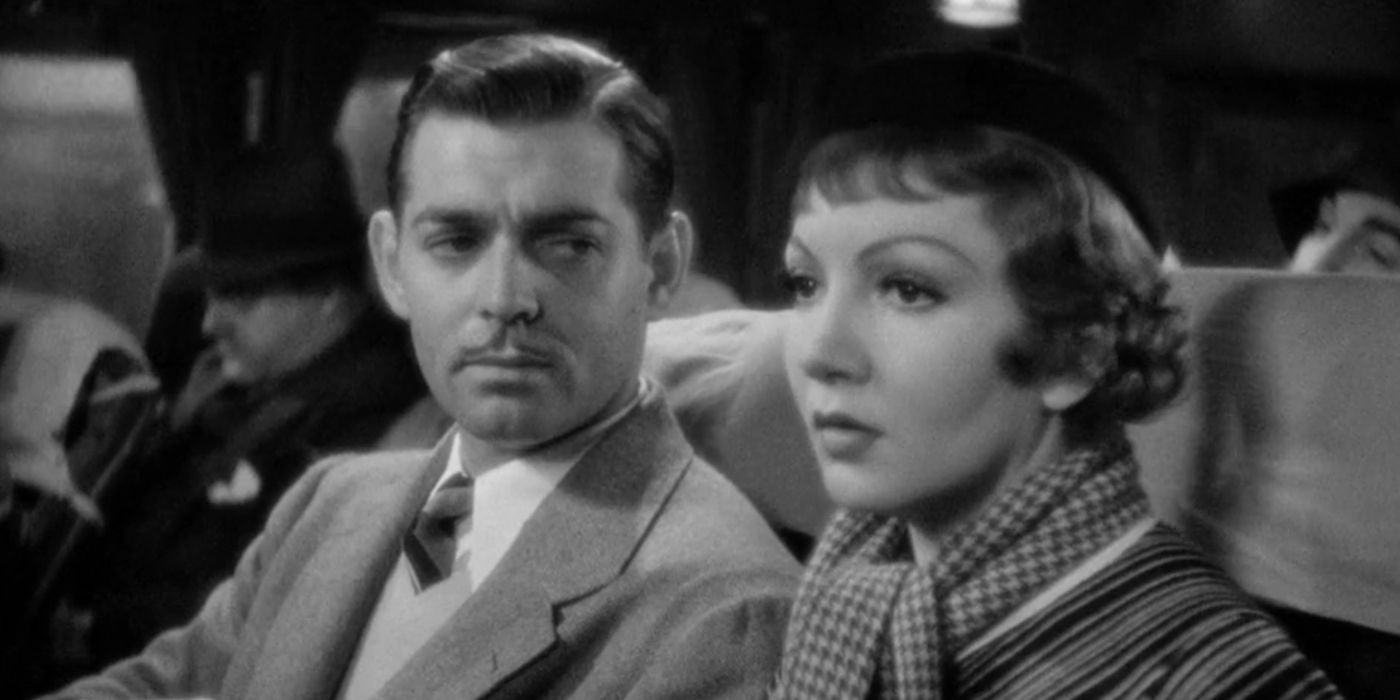 Peter Warne (Clark Gable) sits beside Ellie Andrews (Claudette Colbert) in 'It Happened One Night'.