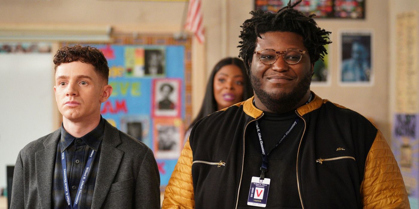 Chris Perfetti as Jacob and Larry Owens as Zach stand next to one another awkwardly in Abbott Elementary.