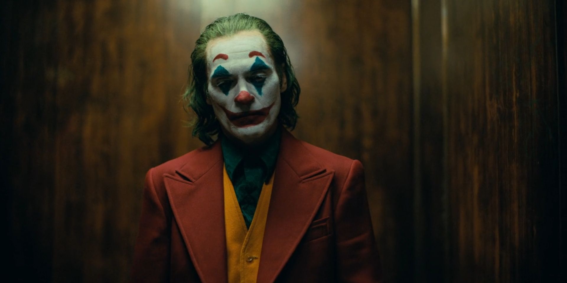 Arthur Fleck, played by Joaquin Phoenix, wears full clown make-up in an elevator in 2019's 'Joker'.