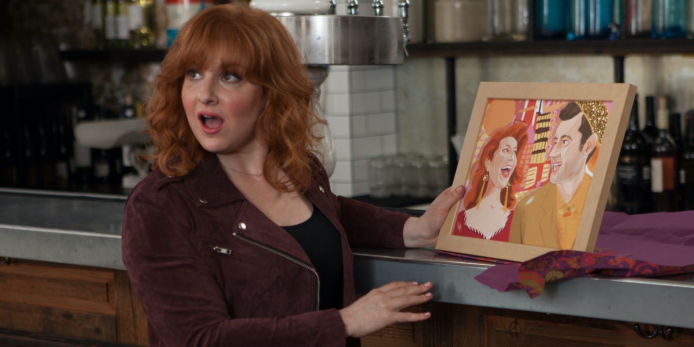 Julie Klausner holding up a painting of herself and Billy Eichner in the Hulu series Difficult People.