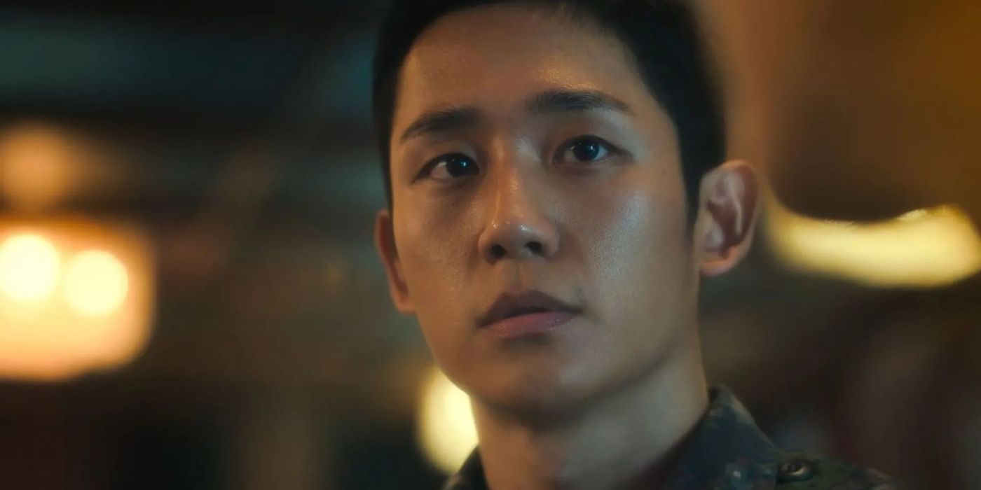 A closeup of Jung Hae-in looking at someone to his left while he listens in the military drama D.P.