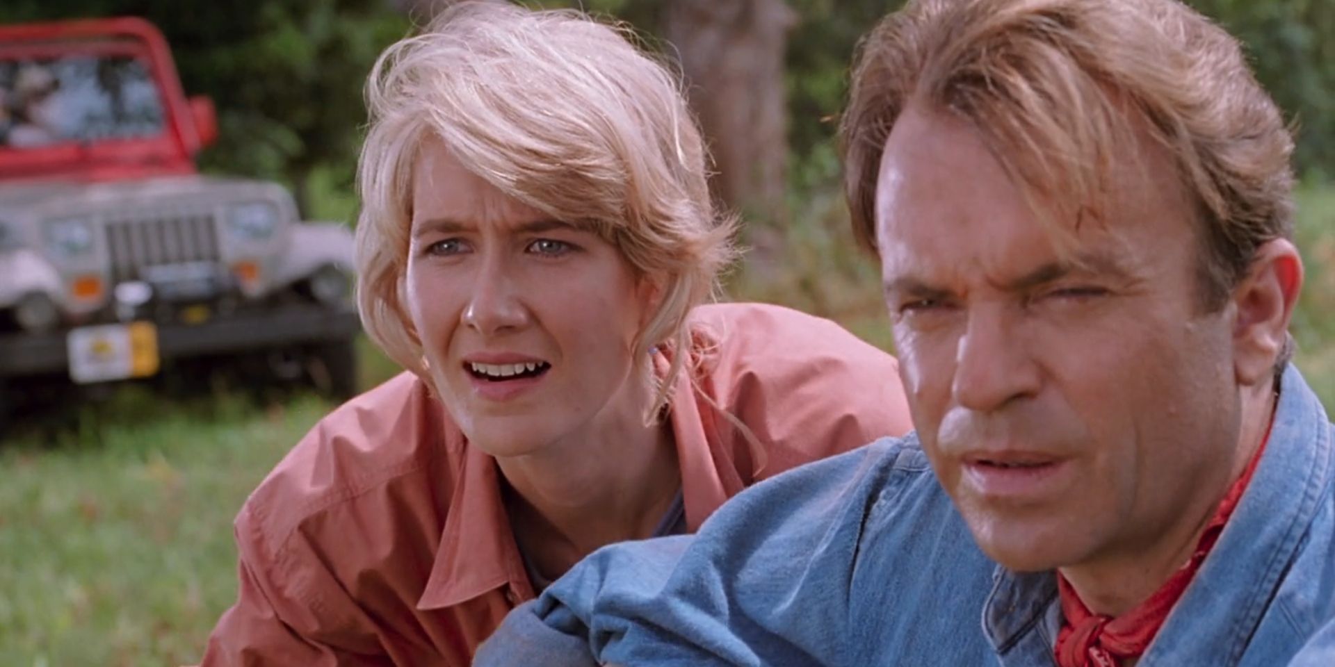 Ellie Sattler, played by Laura Dern, and Alan Grant, played by Sam Neill, look amazed in 'Jurassic Park'.