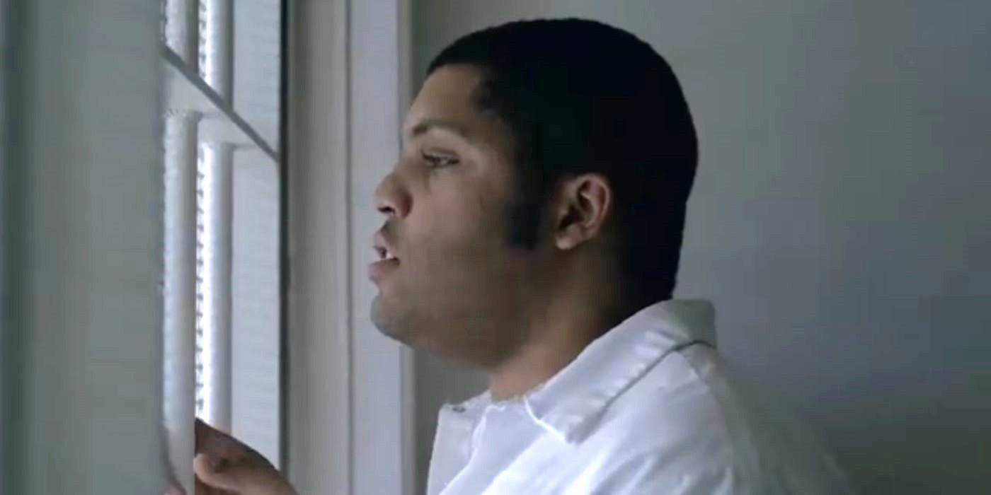 O'Shea Jackson Jr. as Anthony Ray Hinton in a white jumpsuit behind bars in Just Mercy.