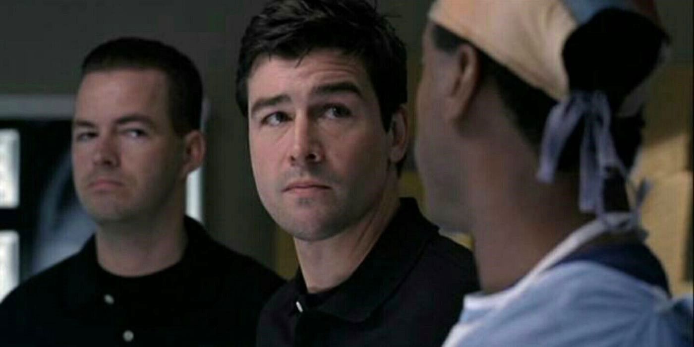 Kyle Chandler as Dylan Young looks at a doctor in scrubs with X-rays in the background on Grey's Anatomy.