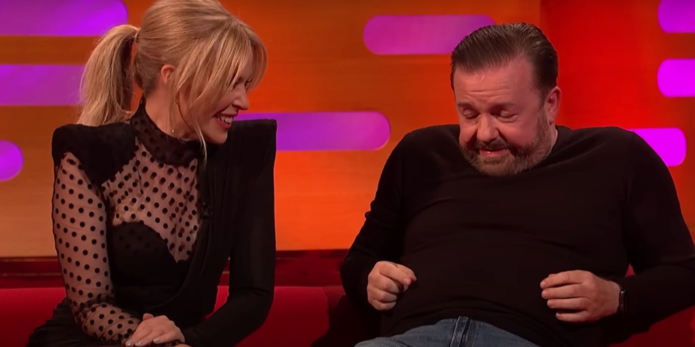 Kylie Minogue singing to Ricky Gervais while seated next to each other on the couch on The Graham Norton Show