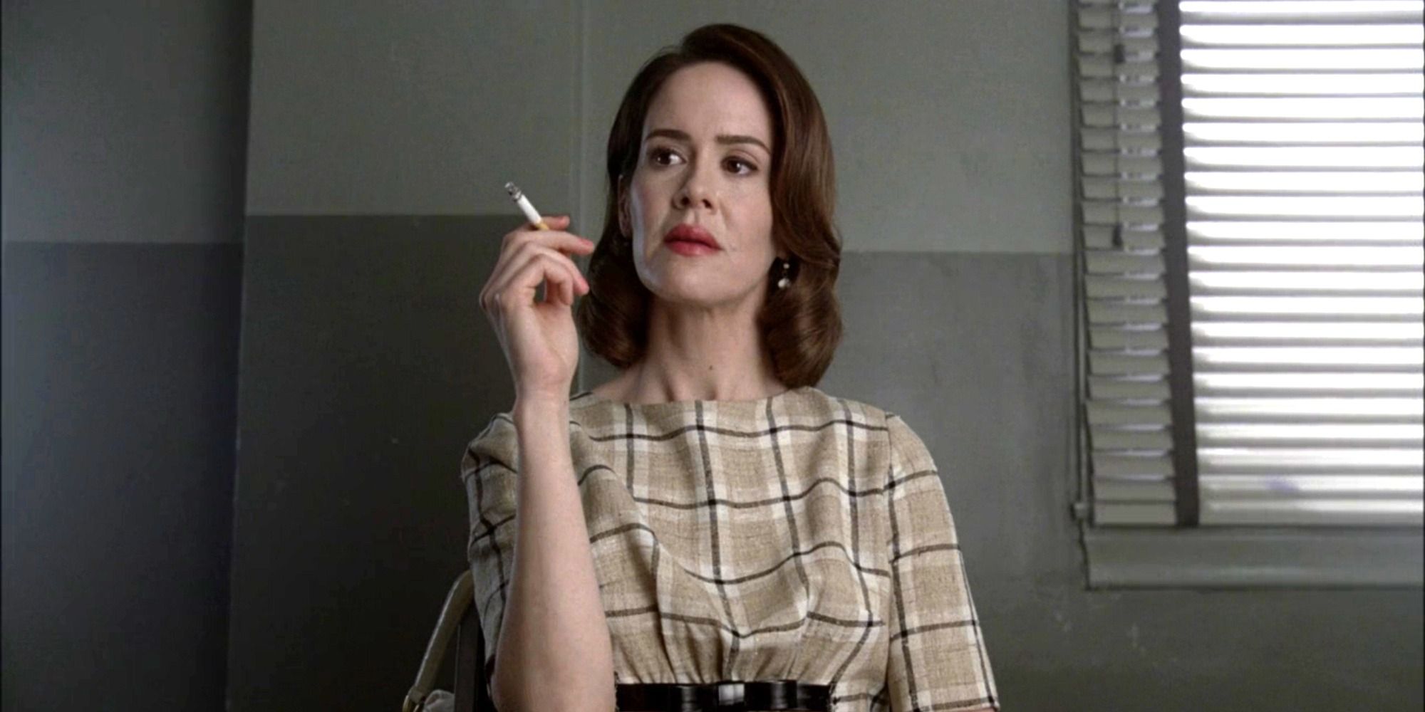 Lana Winters (Sarah Paulson) holding a cigarette in episode 11 of &lsquo;American Horror Story: Asylum.'