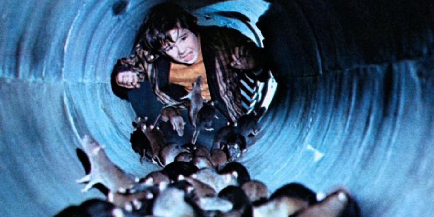 A child, scared, walking through a tunnel full of rats in 'Ben' (1972)