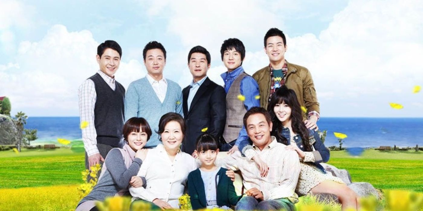 The cast of K-drama Life is Beautiful (2010) pose for a promo photo with a field of flowers backdrop.