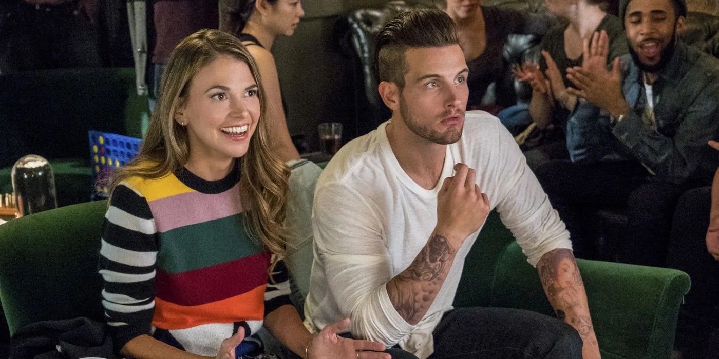 Liza (Sutton Foster) and Josh (Nico Tortorella) at a sitting on a couch during a trivia night in Younger