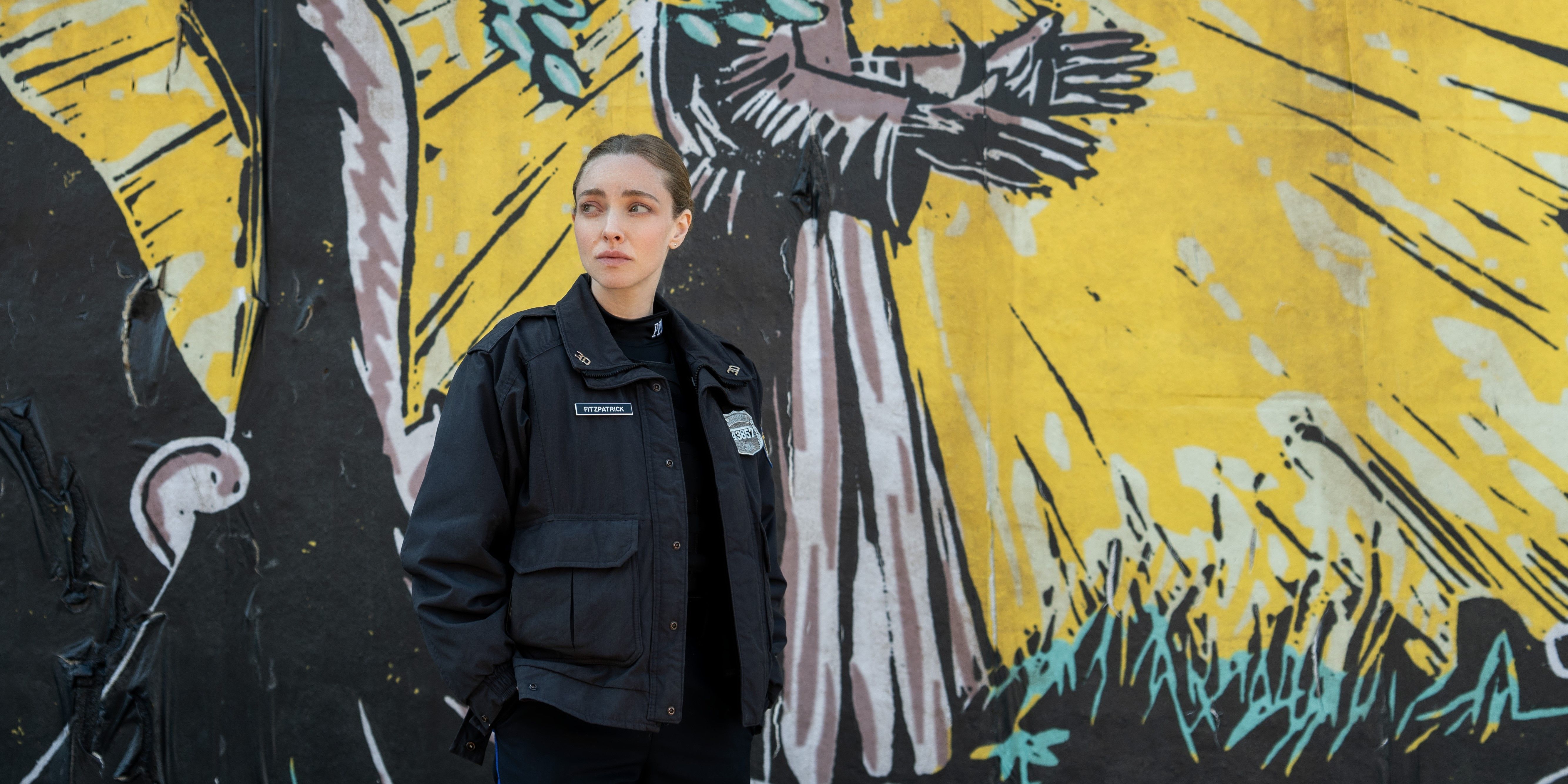 Amanda Seyfried standing in front of a mural in Long Bright River