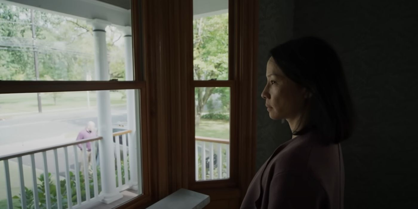 Lucy Liu as Rebecca looking out a window in 'Presence'.