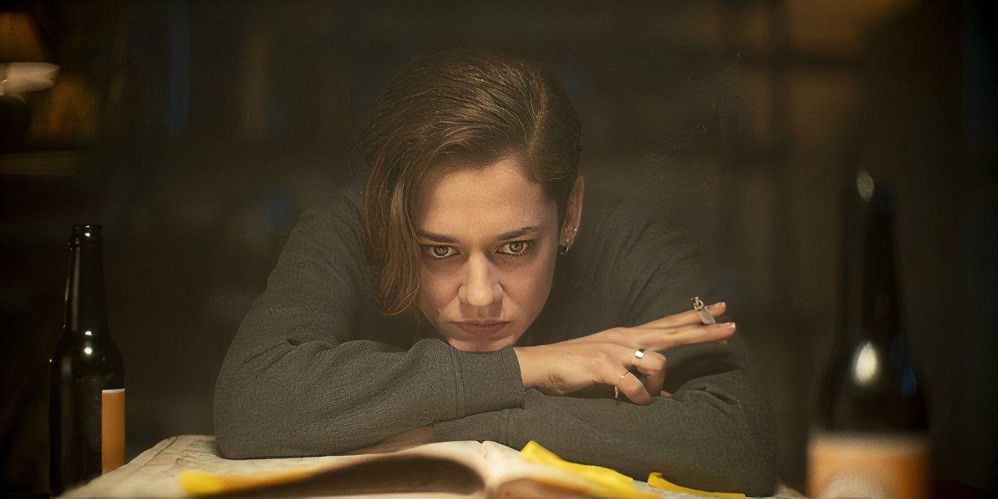 A woman resting her head on a table in Marianne