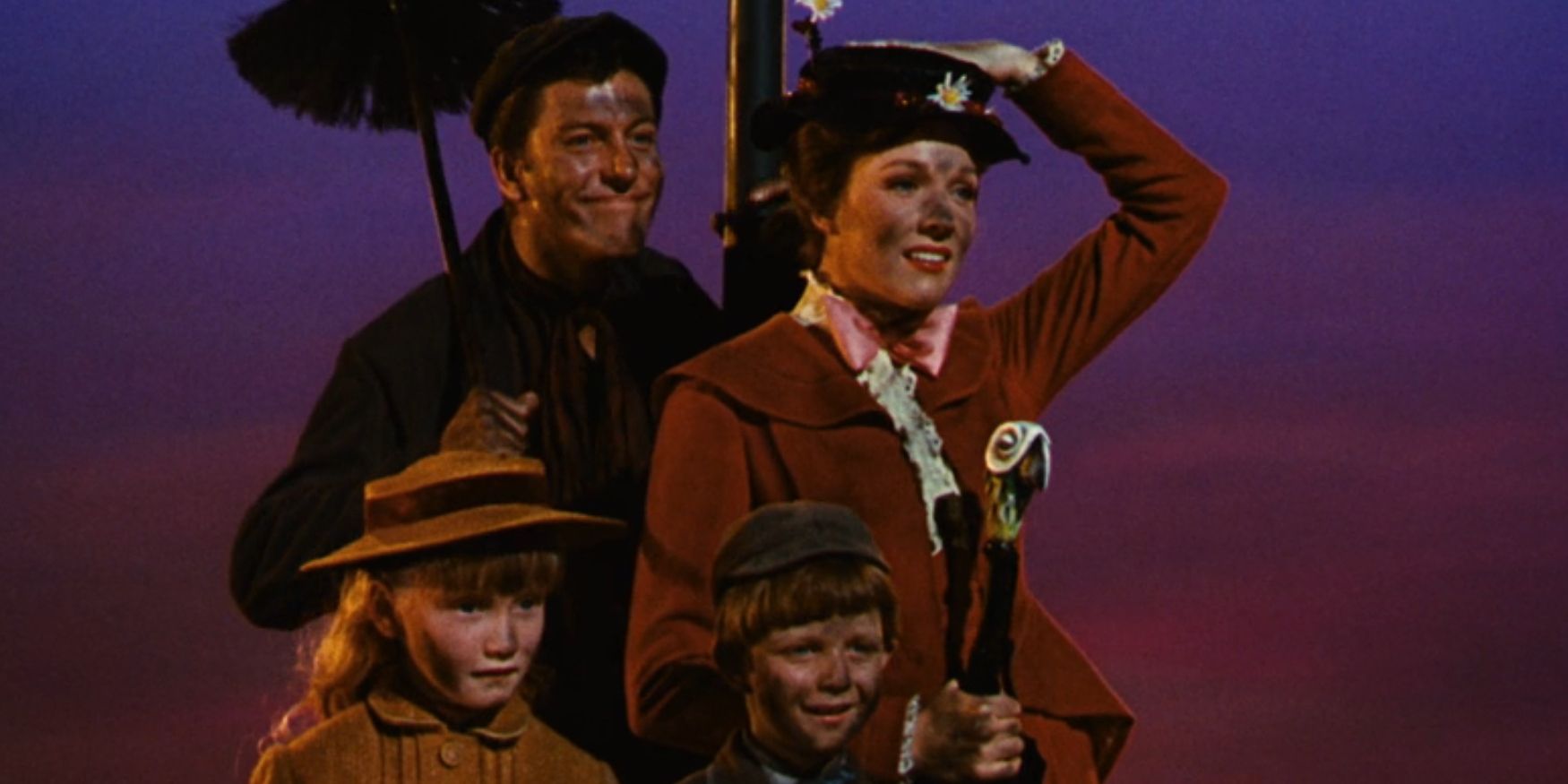 Bert, Mary Poppins and the Banks siblings stand atop a roof with soot on their faces in 'Mary Poppins'.