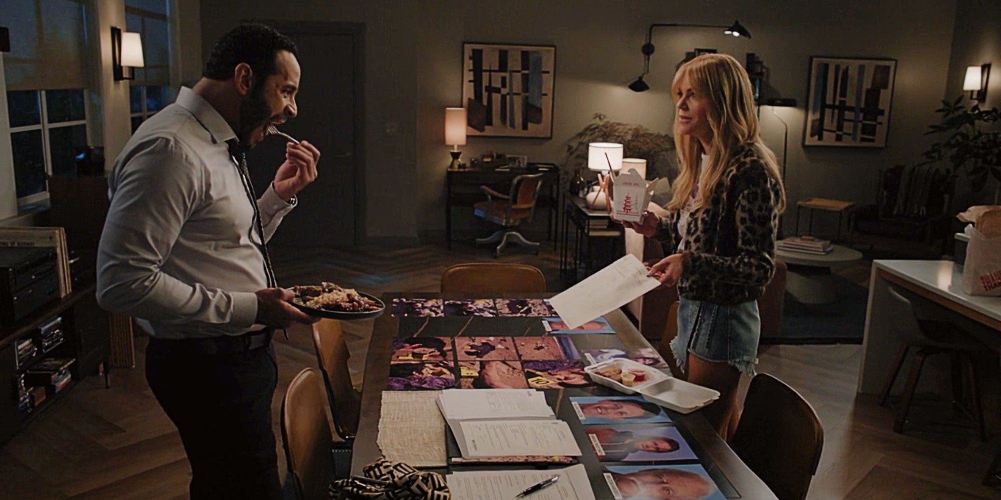 Karadec and Morgan stand and eat Chinese food while looking at files in High Potential Season 1 Episode 8.