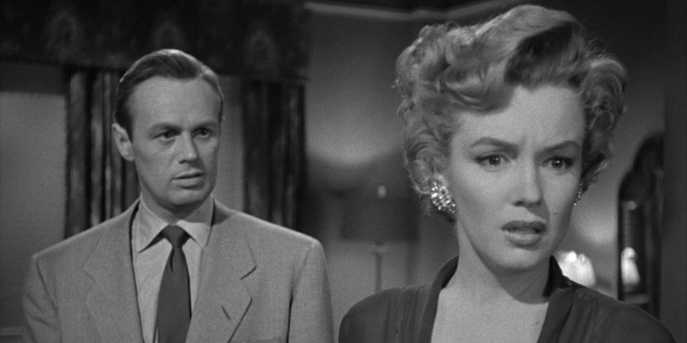 Nell (Marilyn Monroe) is upset as Jed (Richard Widmark) looks on in 'Don't Bother to Knock'