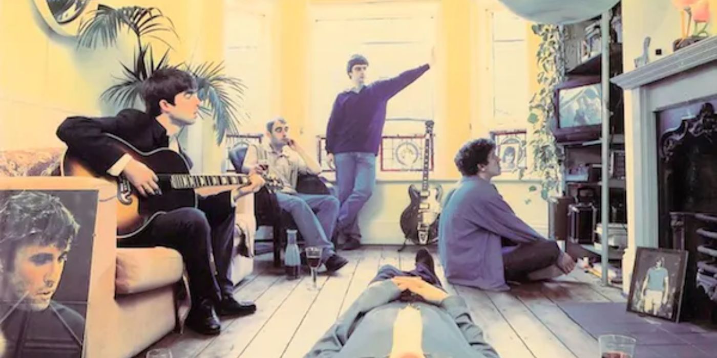 The band sit on the floor and a sofa and look at a small TV on Oasis' album cover for Definitely Maybe (1994).