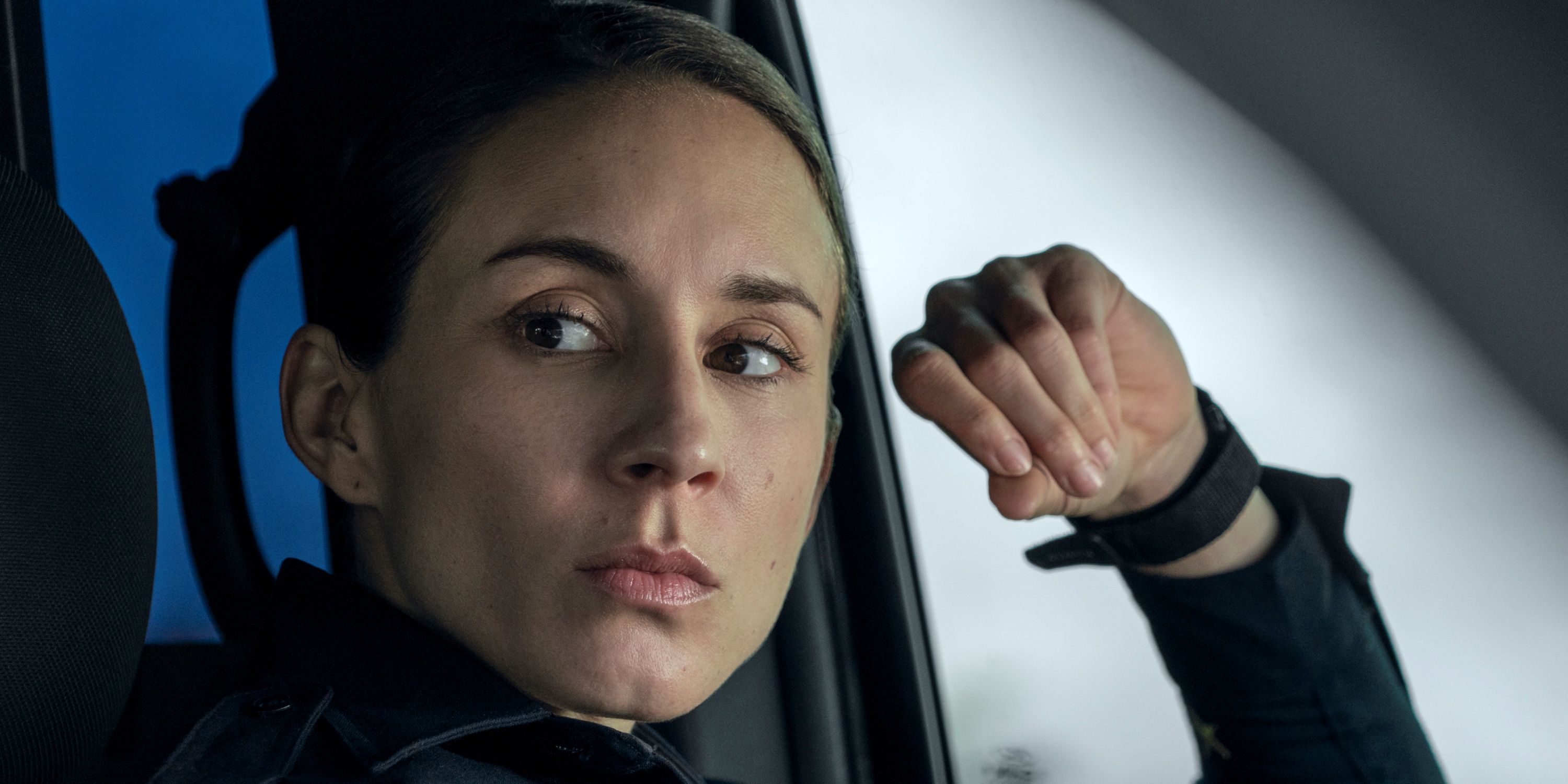 Troian Bellisario as Harmon close up and looking to the right while leaning on the left car door in On Call