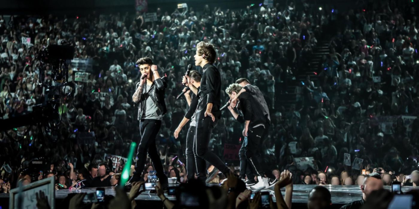 One Direction performing on stage in 'One Direction: This Is Us'.