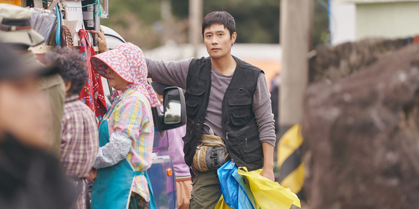 Lee Byung-hun standing in a crowded street in Our Blues.