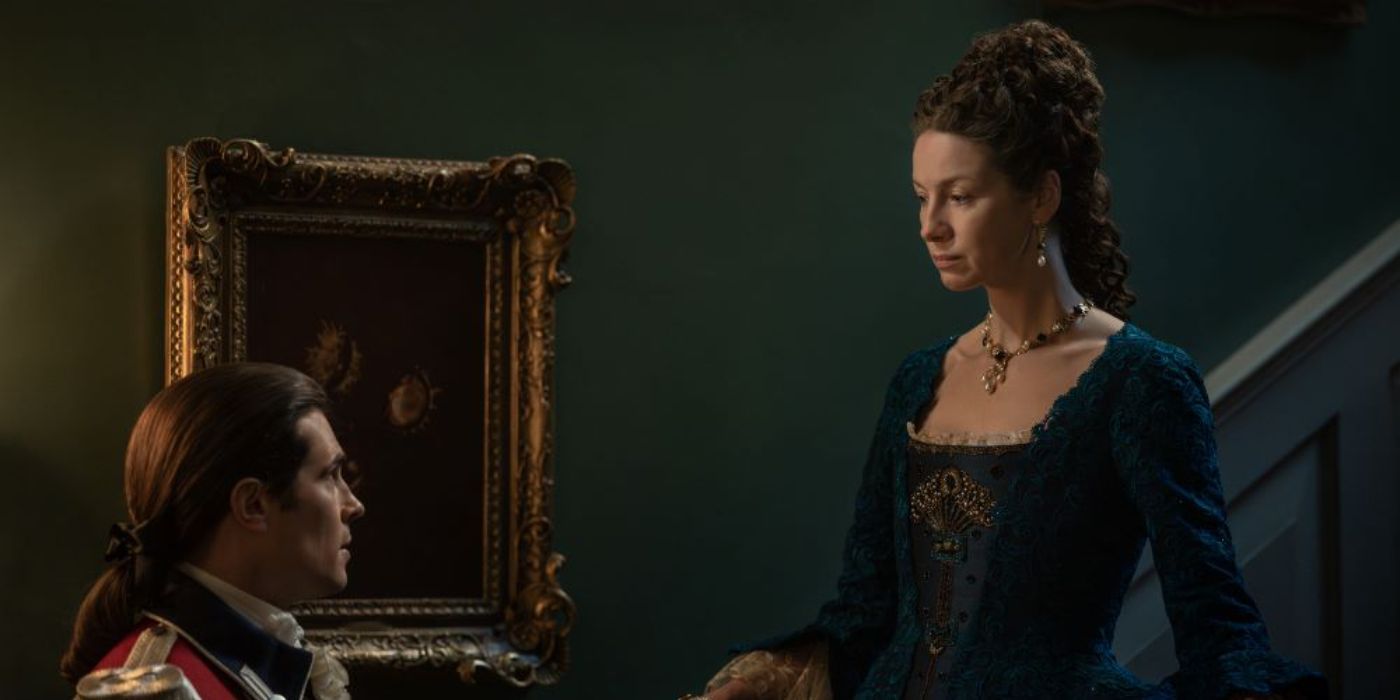 David Berry as John Grey talks to Caitriona Balfe as Claire on a staircase in Outlander Season 7, Episode 11.