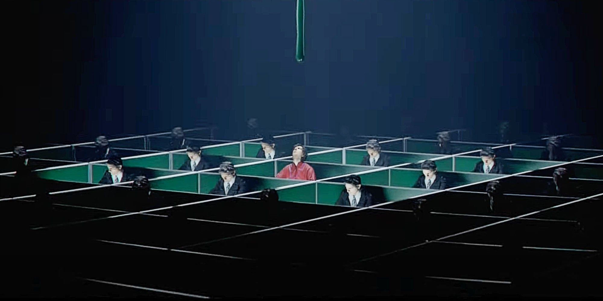 A still from the opening credits of Severance Season 1: a tiny Mark in red pajamas sits at a cubicle surrounded by Marks in Suits as paint drips down from above