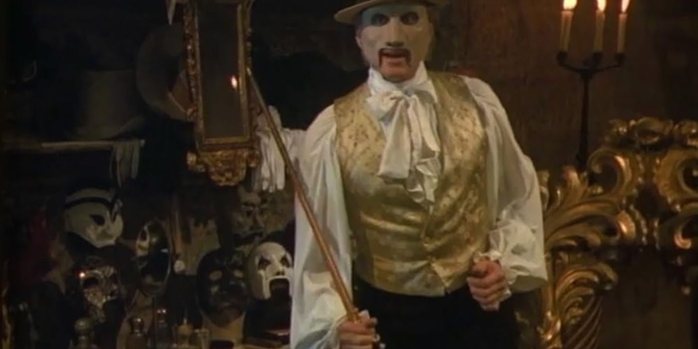 The Phantom in a mask stands in front of his vanity full of masks in The Phantom of the Opera TV miniseries.