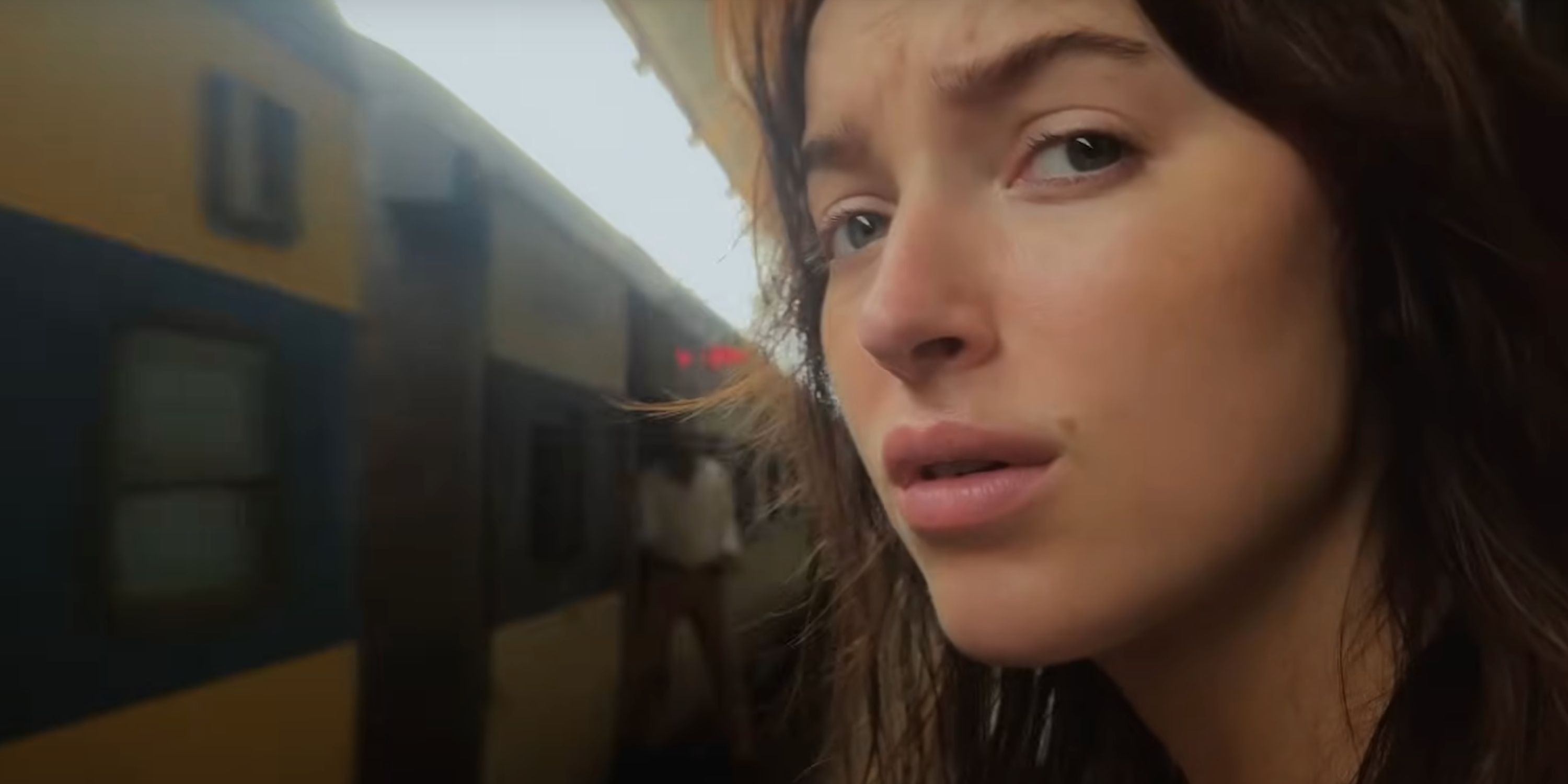 Phoebe Dynevor as Maya standing next to a train in &lsquo;Inheritance&rsquo;
