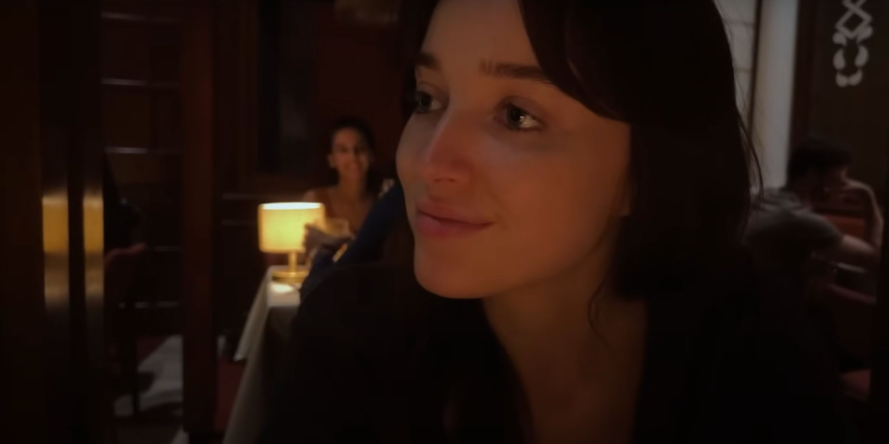 Phoebe Dynevor as Maya looking across the table in &lsquo;Inheritance&rsquo;
