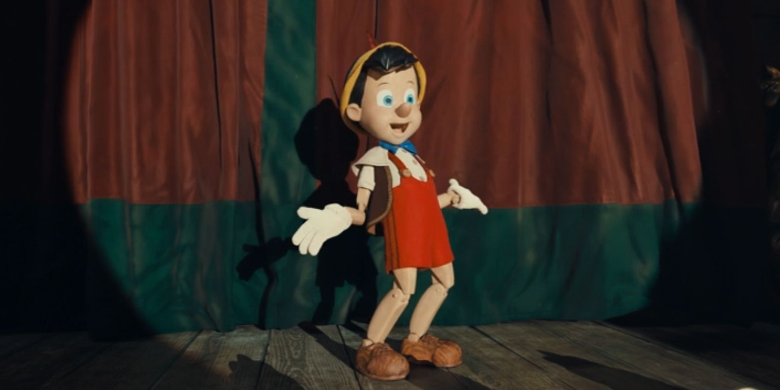 Pinocchio, played by Benjamin Evan Ainsworth, puts his arms out while on stage in 2022's 'Pinocchio'.