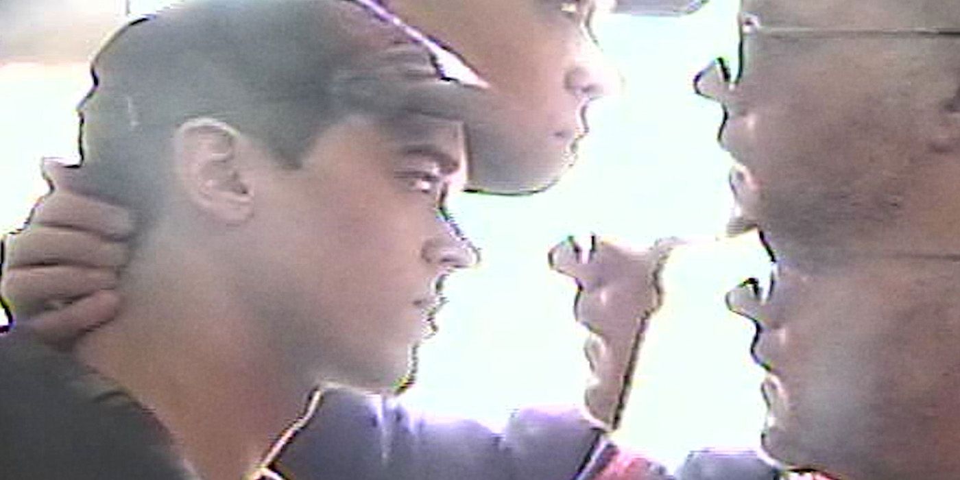 Distorted image of Andrew (Russell Tovey) holding the back of Lucas' (Tom Blyth) neck in Plainclothes