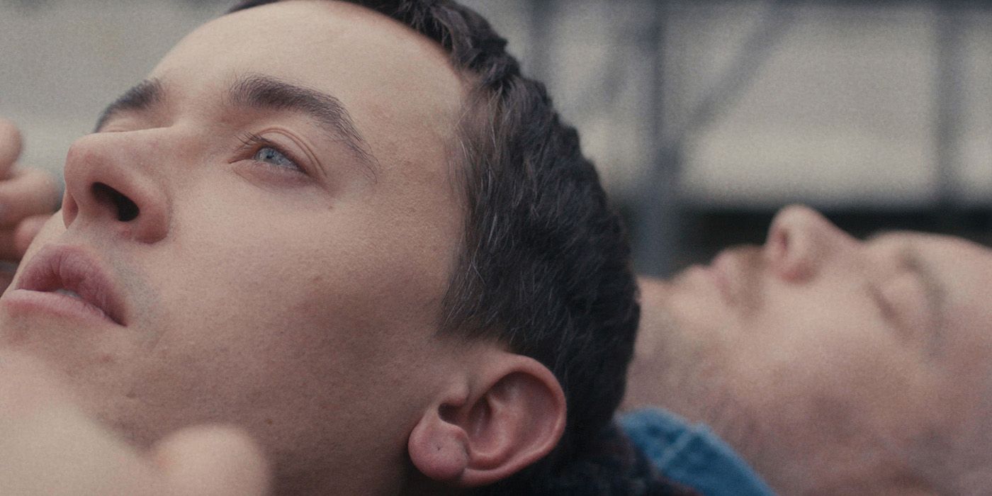 Close-up of Lucas (Tom Blyth) lying with Andrew (Russell Tovey) in Plainclothes