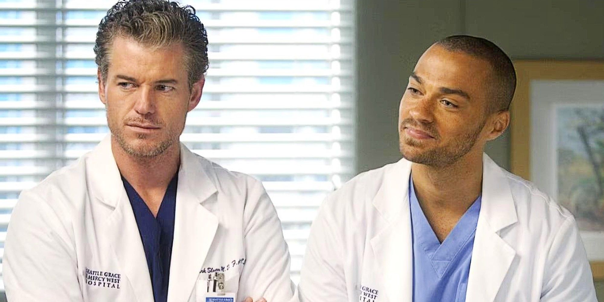 Mark Sloan and Jackson Avery standing together at the hospital in Grey's Anatomy Season 8.