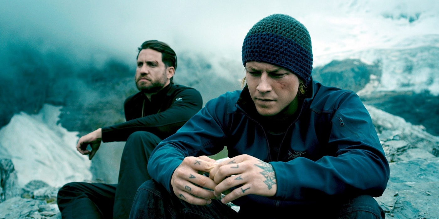 Bodhi (Edgar Ramirez) & Johnny Utah (Luke Bracey) sit on top of a mountain in Point Break (2015)