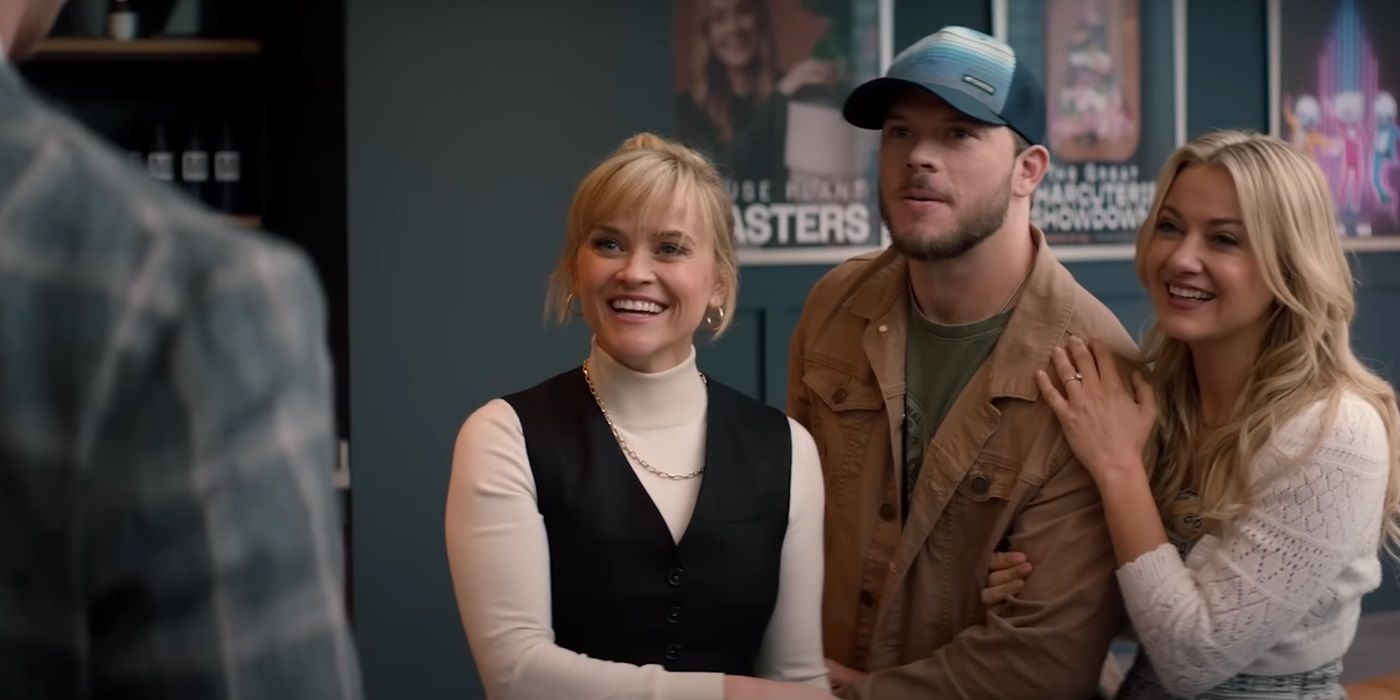 Reese Witherspoon, smiling in office, as Margot in You&rsquo;re Cordially Invited